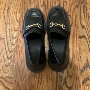 Black loafer with gold hardware